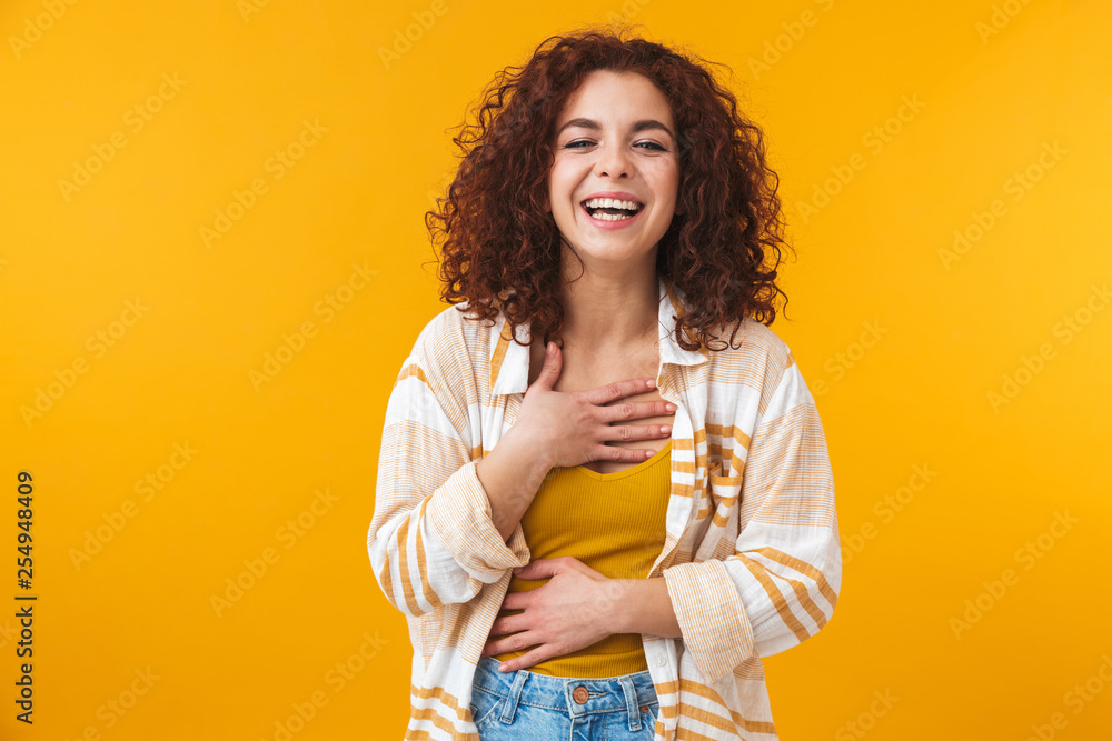 Image of pleased woman 20s with curly hair standing and laughing Image of pleased woman 20s with curly hair standing and laughing