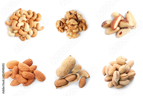 Set of different delicious organic nuts on white background, top view