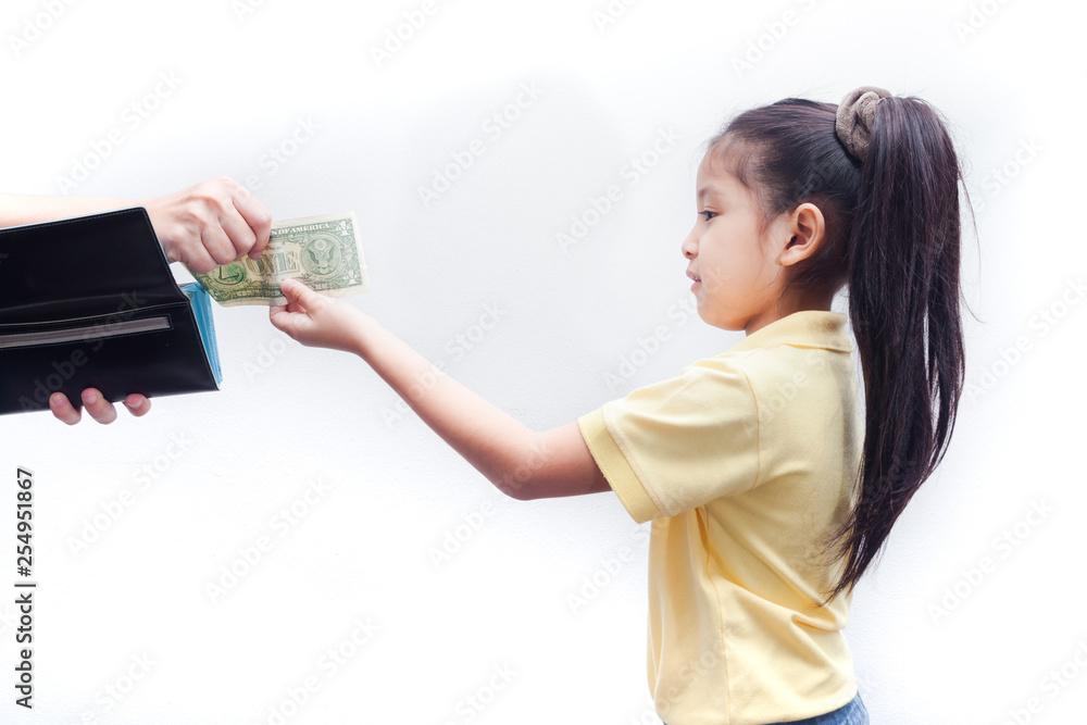 Young girl receive american bank note from parent. Young girl receive american bank note from parent.