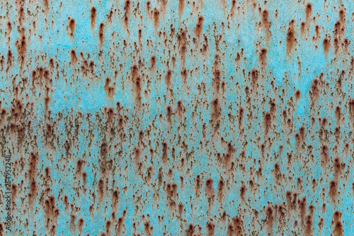 A beautiful horizontal texture of blue metal sheet with orange rust and holes