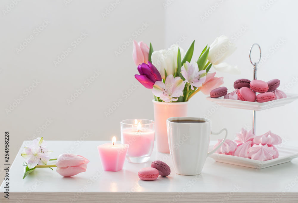  Tulips in vase and cup of coffee with dessert on white backgrou