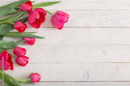 Fototapeta Naklejka Na Ścianę i Meble -  pink tulips on white wooden background