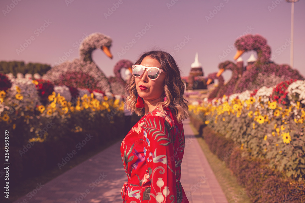 Fototapeta premium woman like a litte girl playing on the sun of dubai