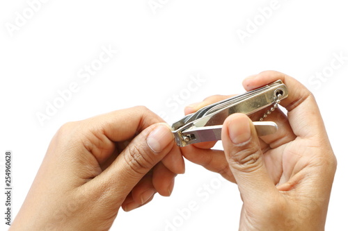 Closeup isolated of Asian woman holding steel scissors cutting her fingernail on white background