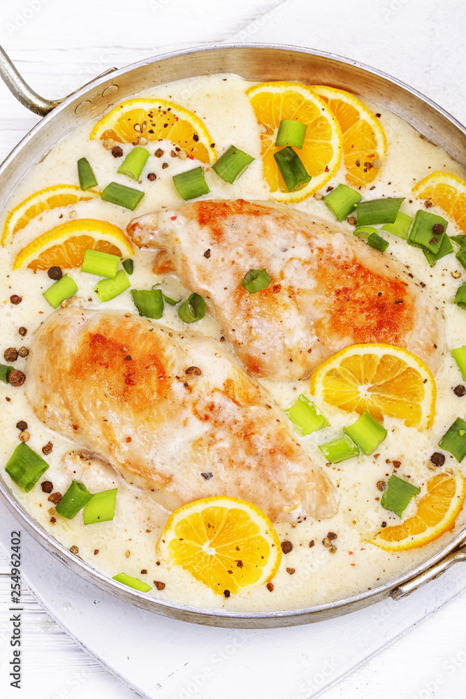 Chicken with lemons on white background Chicken with lemons on white background