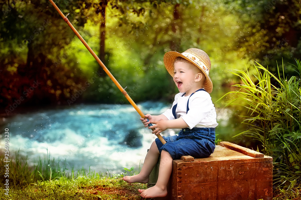 Portrait of cute caucasian blondie baby boy with fishing rod in