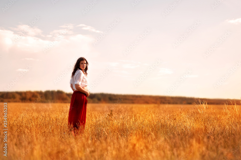 Happy pregnant woman outdoors in summer field. Maternity, harmony, pacification concept