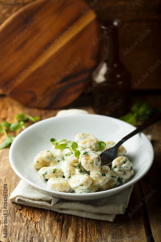Homemade potato gnocchi with creamy basil sauce Homemade potato gnocchi with creamy basil sauce