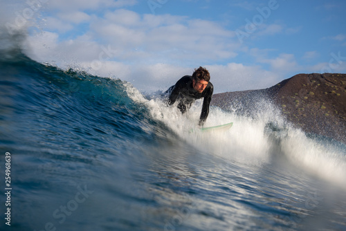 surfer riding waves on the island of fuerteventura in the Atlantic Ocean