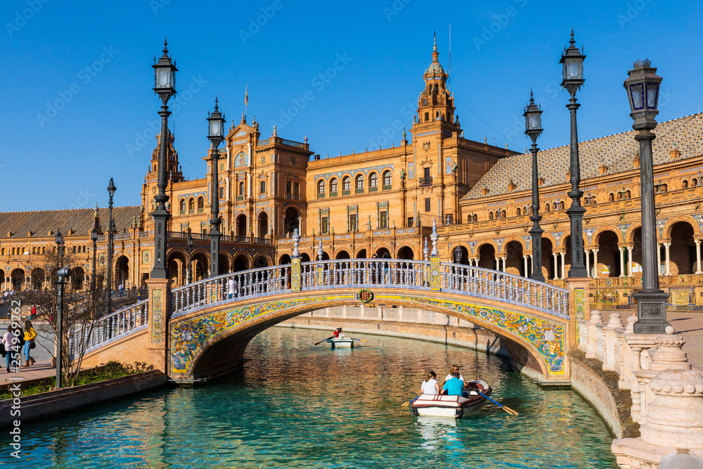 Naklejka premium Seville / Spain: Tourists sailing the boat at the Plaza de Espana - March 2019