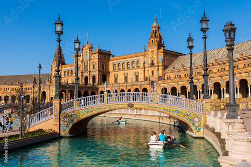Seville / Spain: Tourists sailing the boat at the Plaza de Espana - March 2019