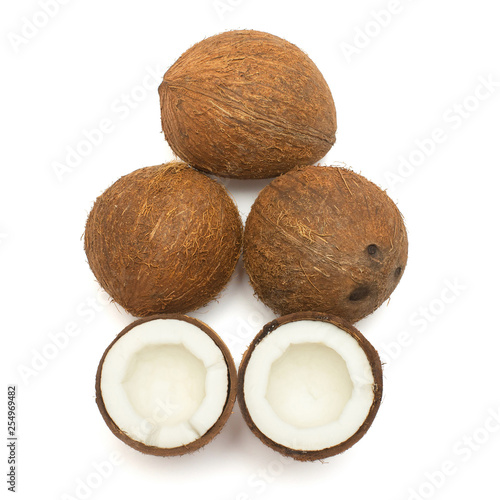 Coconuts whole and half isolated on white background. Tropical fruit. Flat lay, top view