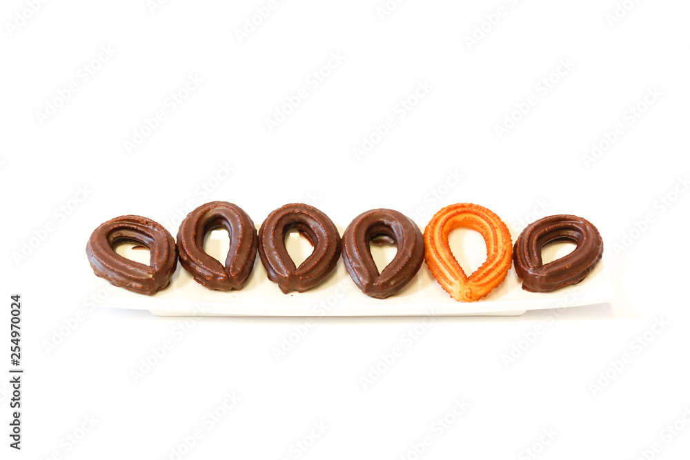 small chocolate spanish fritters in a white dish on white background small chocolate spanish fritters in a white dish on white background