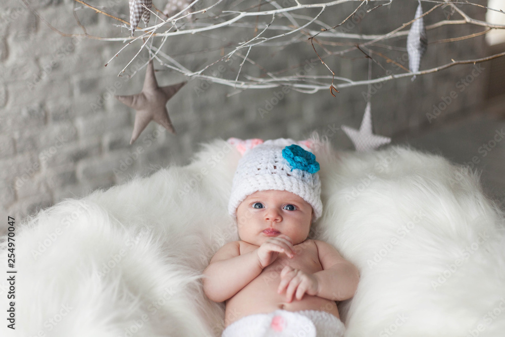 Little cute adorable infant baby girl in knitted hat. Infant, childhood, baby concept Little cute adorable infant baby girl in knitted hat. Infant, childhood, baby concept