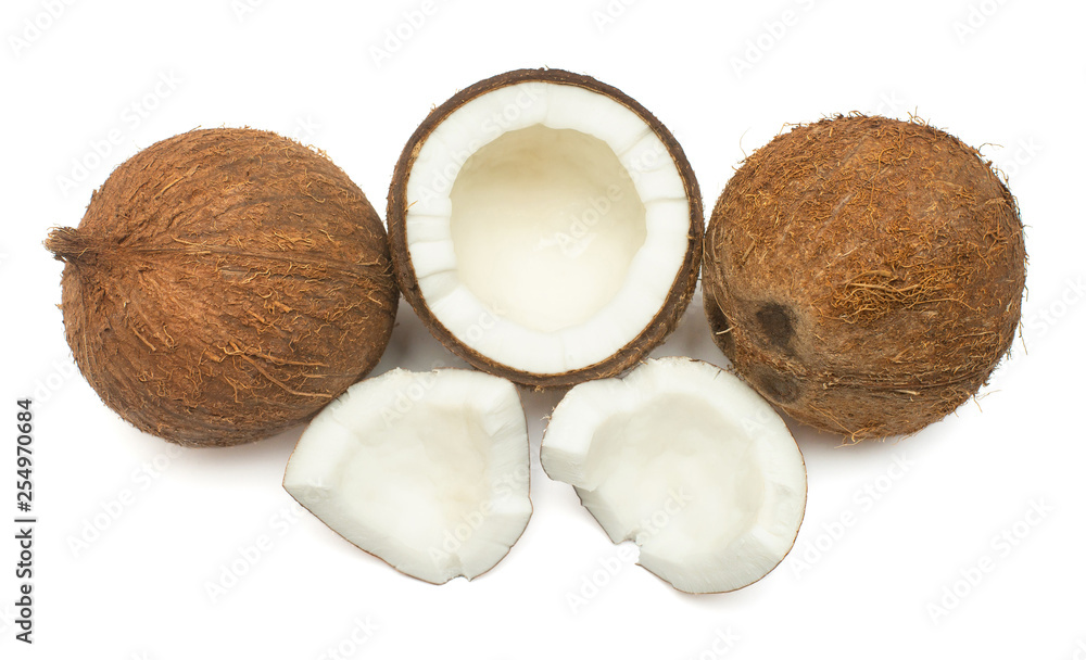 Coconuts whole, half and piece isolated on white background. Tropical fruit. Flat lay, top view Coconuts whole, half and piece isolated on white background. Tropical fruit. Flat lay, top view
