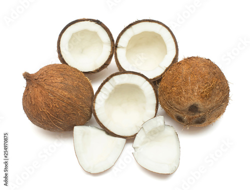 Coconuts whole, half and piece isolated on white background. Tropical fruit. Flat lay, top view