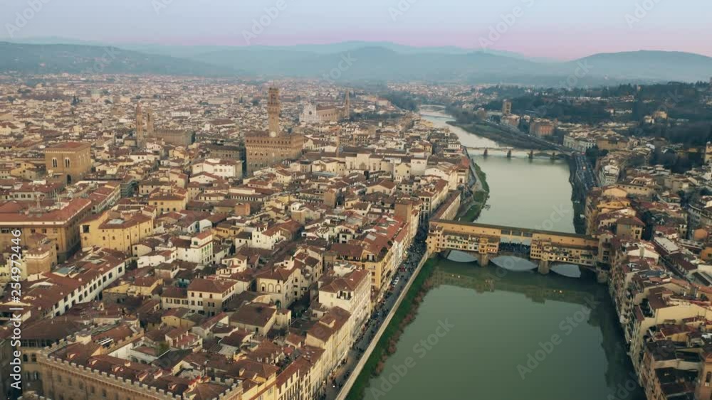 Crowded Ponte Vecchio bridge in the evening, aerial view. Florence, Italy Crowded Ponte Vecchio bridge in the evening, aerial view. Florence, Italy