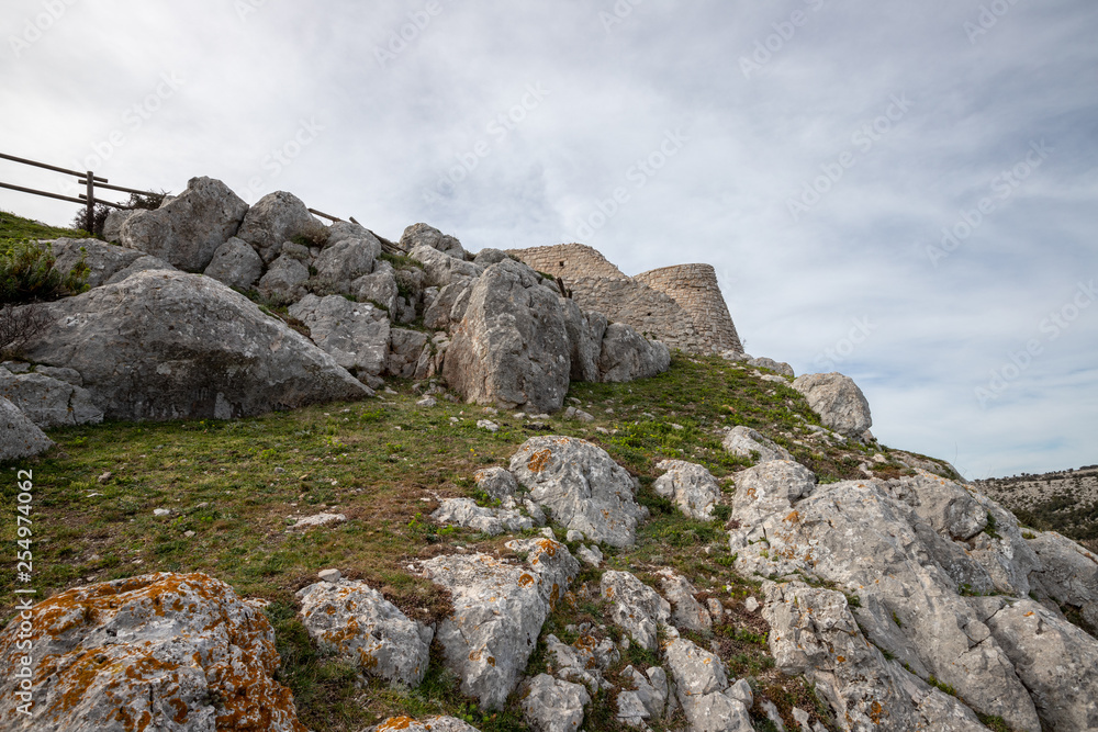 the ruins of Castel Pagano, built by the Normans, castle, church and necropoli built on the rocks. An archeological site in Gargano National Park, Apulia, Italy