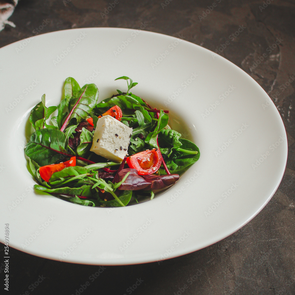 Healthy salad, leaves salad mix in a white plate and cheese (green, juicy snack). food background - Image Healthy salad, leaves salad mix in a white plate and cheese (green, juicy snack). food background - Image