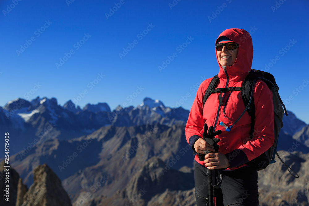 Happy hiker on top of a mountain in the French Alps. Pointe des Cerces, Nevache.