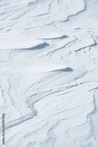 Fresh snow background texture. Winter background with snowflakes and snow mounds. Snow lumps.