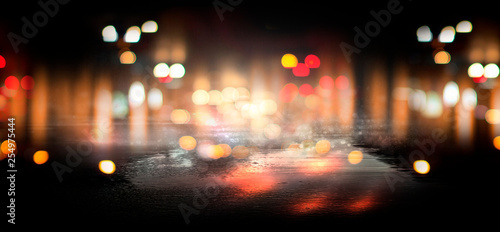 Wet asphalt, reflection of neon lights, a searchlight, smoke. Abstract street with smoke, smog. Night background, night city Abstract bokeh light, night bokeh. © MiaStendal