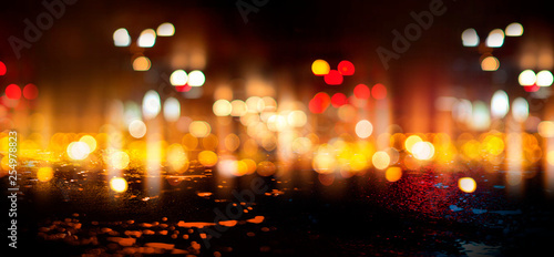 Wet asphalt, reflection of neon lights, a searchlight, smoke. Abstract street with smoke, smog. Night background, night city Abstract bokeh light, night bokeh.