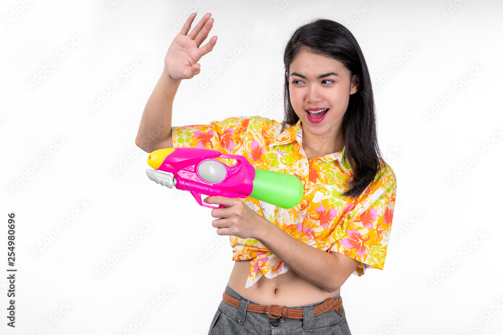 Portrait Beautiful asian woman Take Plastic gun on blue background. water gun party or Songkran festival, Thailand. Thai New Year's Day Portrait Beautiful asian woman Take Plastic gun on blue background. water gun party or Songkran festival, Thailand. Thai New Year's Day
