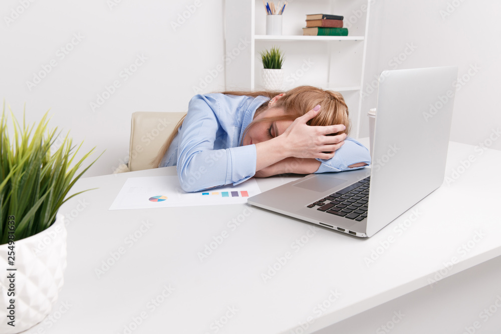 Young office girl sitting at her workplace feeling bad. Woman has a headache Young office girl sitting at her workplace feeling bad. Woman has a headache