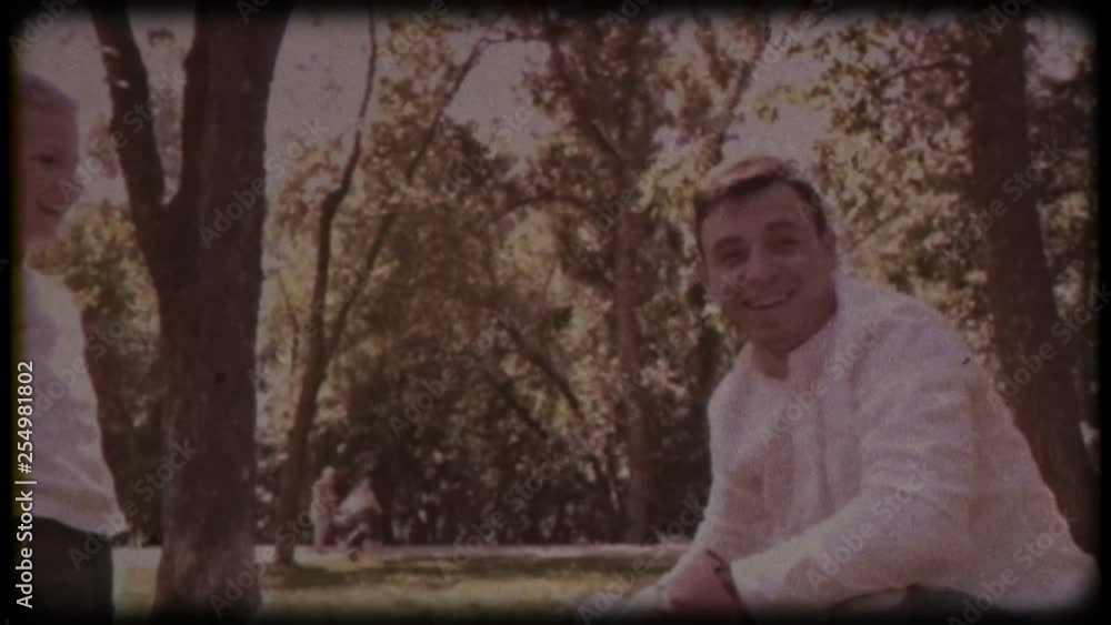 Family video archive. Retro camera 8 mm. Old film. Father and son in boxing gloves play boxing on the lawn near the house. happy childhood. Family video archive. Retro camera 8 mm. Old film. Father and son in boxing gloves play boxing on the lawn near the house. happy childhood.