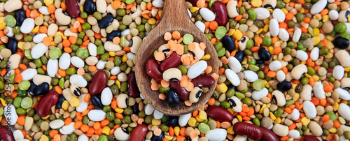 Quadro su tela Mixed dry uncooked legumes full background, banner