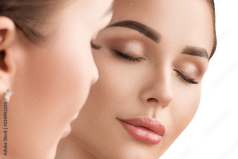 Beautiful girl looks in the mirror. Cosmetology, clean skin Beautiful girl looks in the mirror. Cosmetology, clean skin