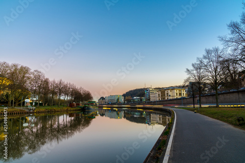 Germany, Saarbruecken city reflecting in saar river at dawn