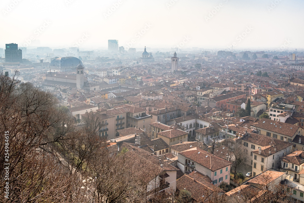 above view of Brescia city with towers in haze