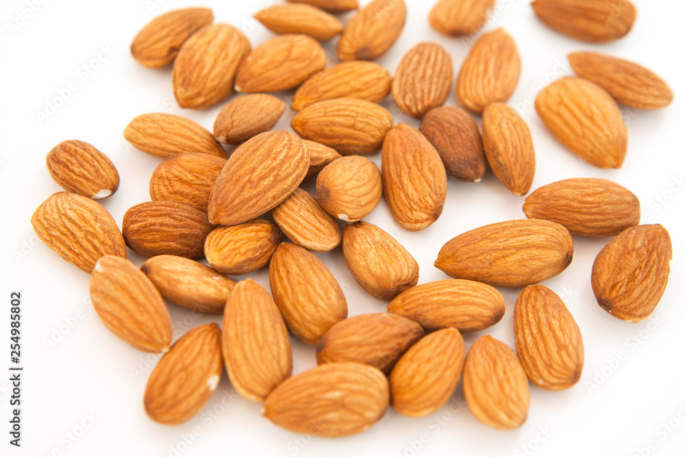 Almond superfood isolated on white background. Concept of healthy life. Close up. Nuts fill the whole frame Almond superfood isolated on white background. Concept of healthy life. Close up. Nuts fill the whole frame
