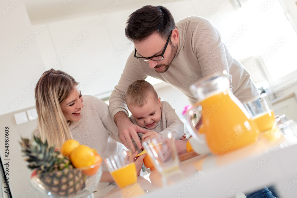 Family make fresh orange juice