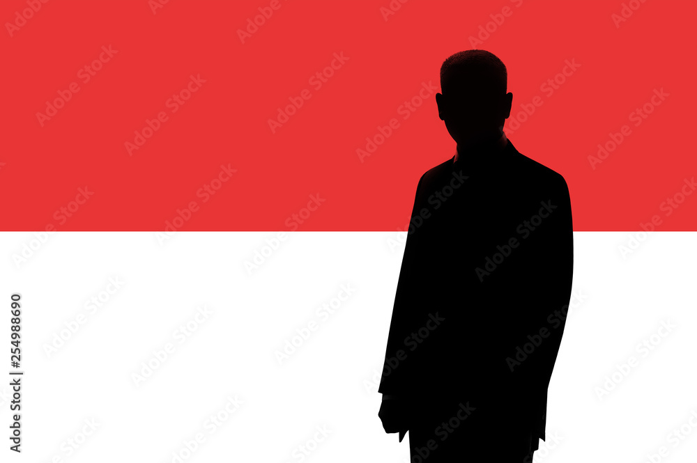 Silhouette of businessman on the background of the Monaco flag. Silhouette of a man, with space for text. Silhouette of businessman on the background of the Monaco flag. Silhouette of a man, with space for text.