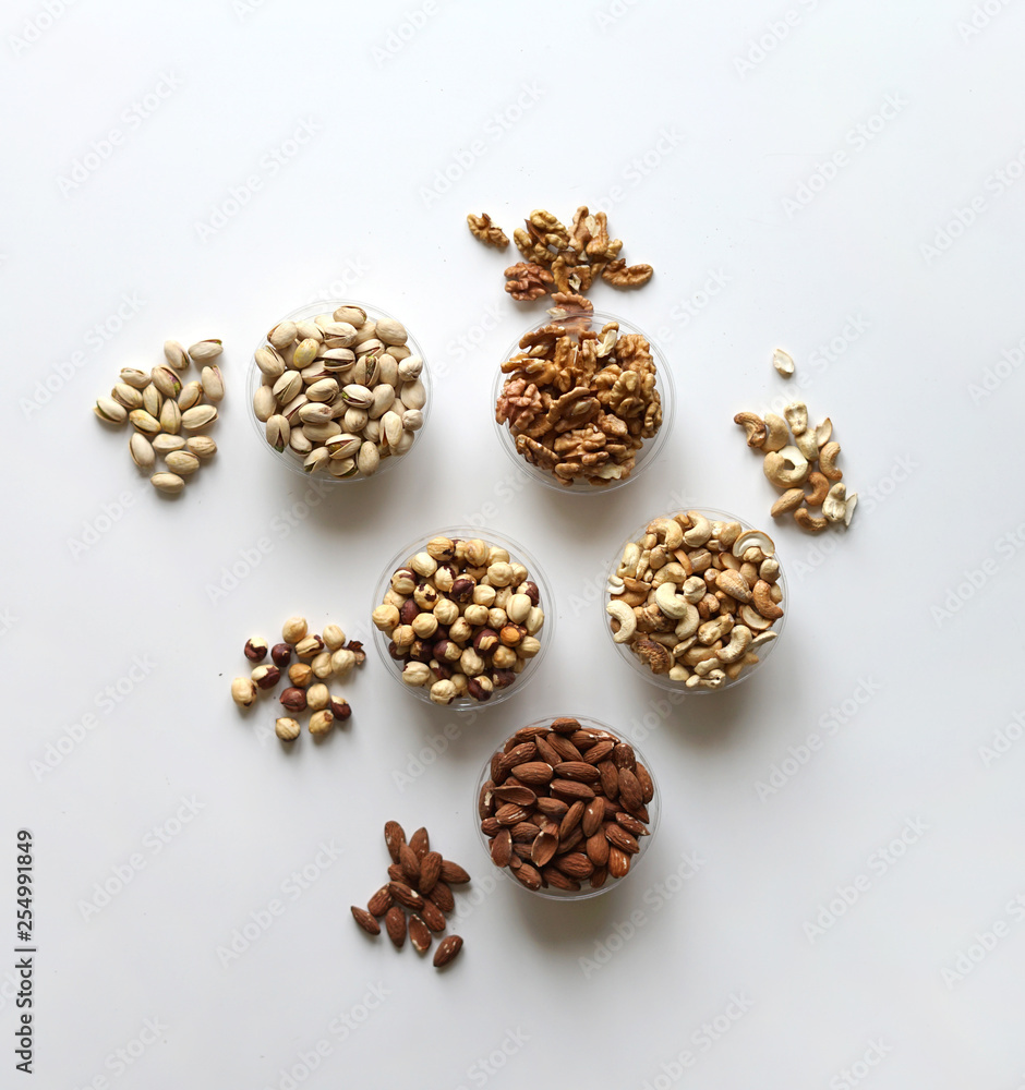 Healthy food. Nuts mix assortment on stone table top view. Collection of different legumes for background image close up nuts, pistachios, almond, cashew nuts, peanut, walnut. image Healthy food. Nuts mix assortment on stone table top view. Collection of different legumes for background image close up nuts, pistachios, almond, cashew nuts, peanut, walnut. image