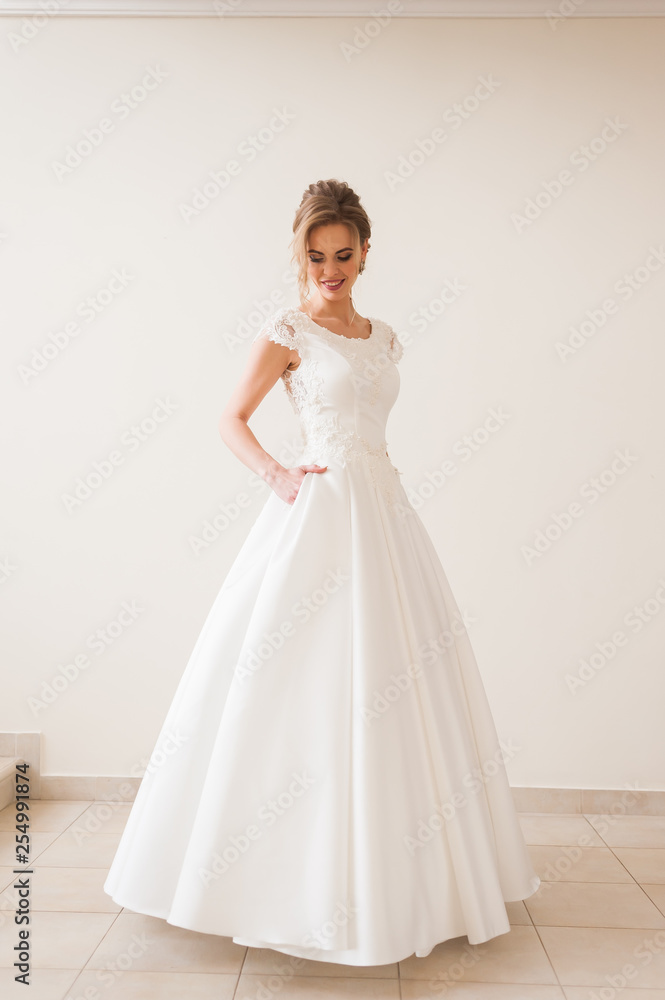 Fashion bride in gorgeous wedding dress studio portrait. Beautiful model with bridal makeup and hairstyle in marriage lace dress. Fashion bride in gorgeous wedding dress studio portrait. Beautiful model with bridal makeup and hairstyle in marriage lace dress.