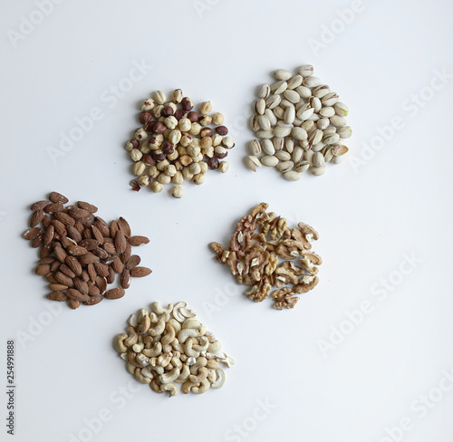 Healthy food. Nuts mix assortment on stone table top view. Collection of different legumes for background image close up nuts, pistachios, almond, cashew nuts, peanut, walnut. image