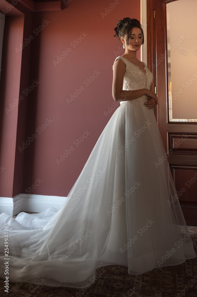 Portrait of a beautiful bride woman in elegant white wedding dress. Luxurious apartments. Portrait of a beautiful bride woman in elegant white wedding dress. Luxurious apartments.