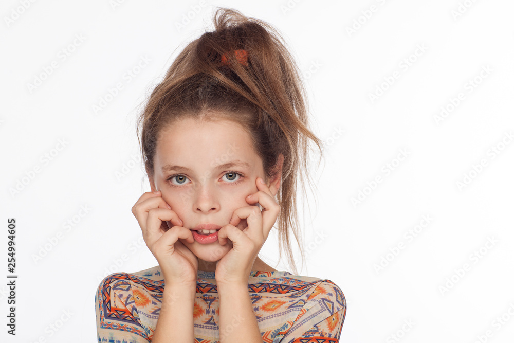 Beautiful emotional 8-year-old girl, with her hair raised up and in a blouse with ornaments Beautiful emotional 8-year-old girl, with her hair raised up and in a blouse with ornaments