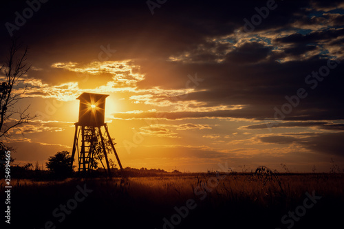 Dark Sunset Landscape with Sun in Hunting Tower
