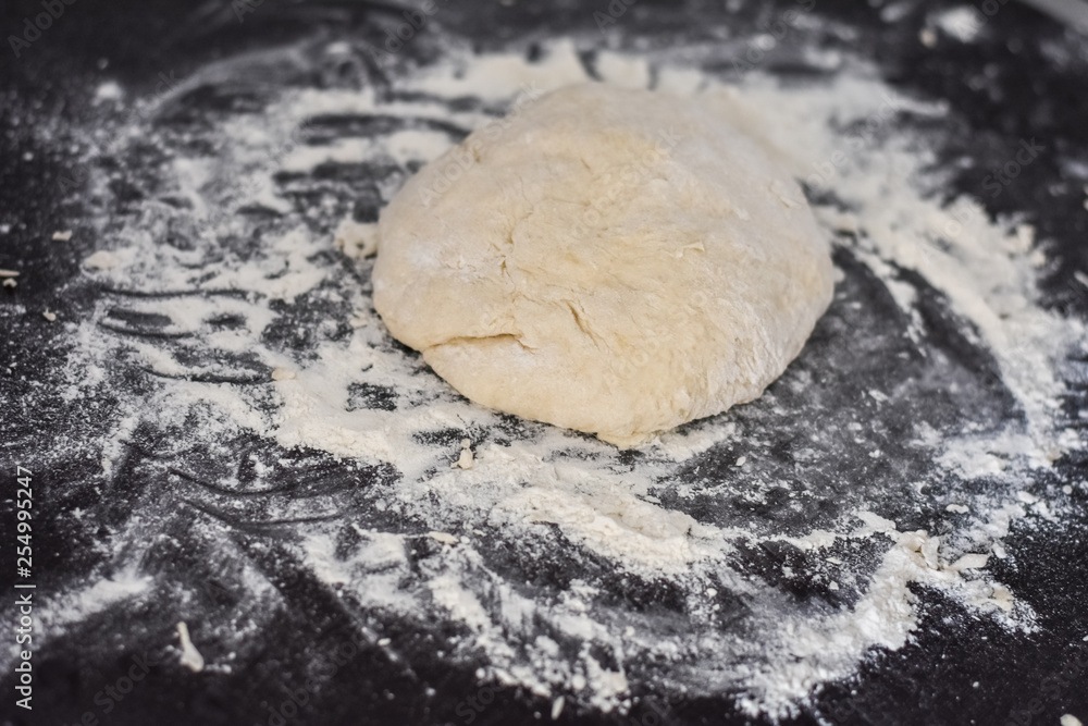dough on a black table, homemade food dough on a black table, homemade food