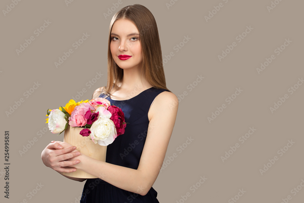 Young beauty woman holding flowers in her hands. Spring image of a lady Young beauty woman holding flowers in her hands. Spring image of a lady