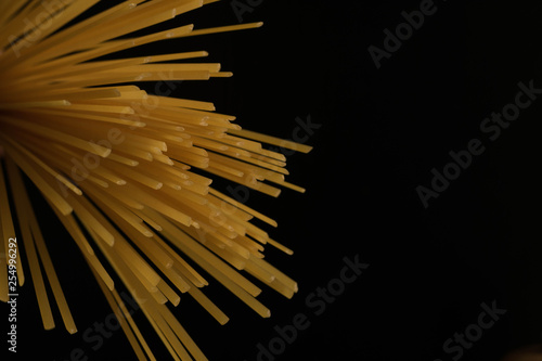 Italian spaghetti raw pasta, dark background