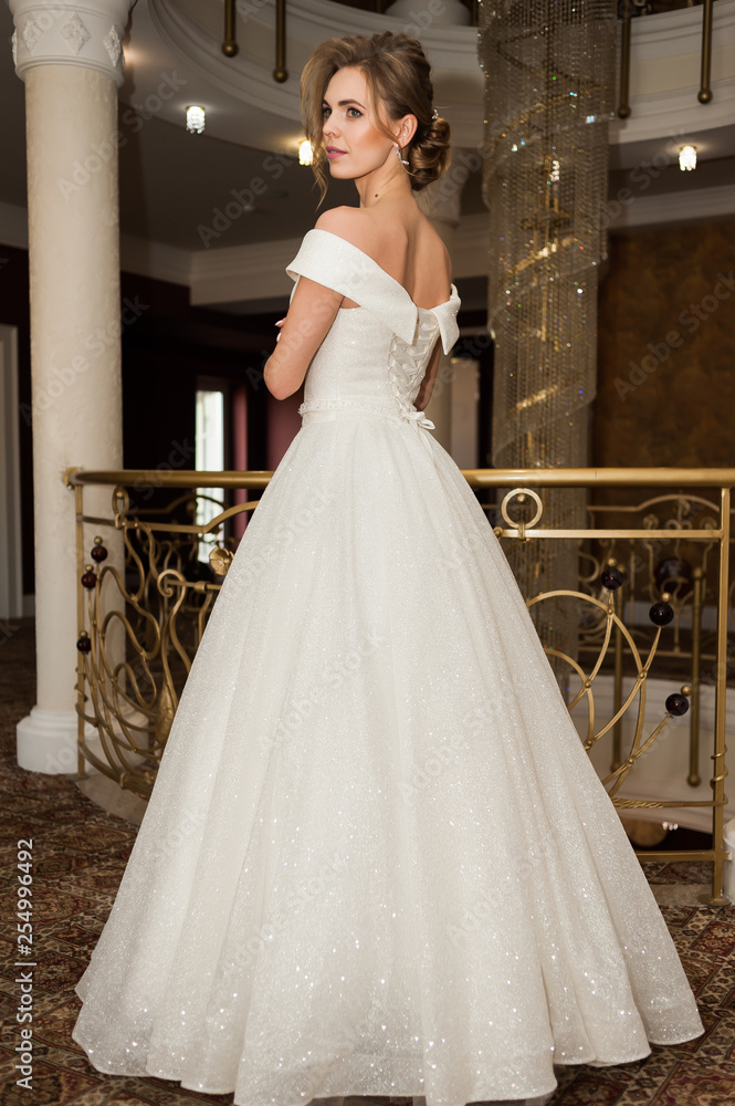 Portrait of a beautiful bride woman in elegant white wedding dress. Luxurious apartments. Portrait of a beautiful bride woman in elegant white wedding dress. Luxurious apartments.