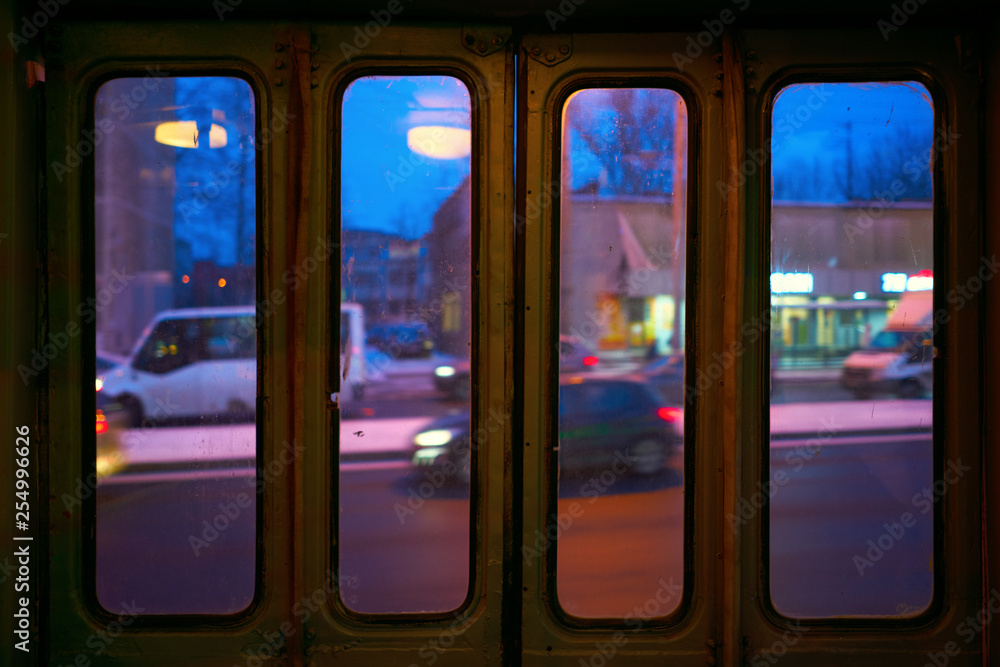 windows in the trolleybus in the door, view of the evening city