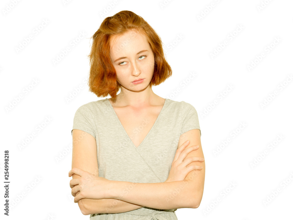 Portrait of redhead displeased and bored girl with crossed arms. Portrait of redhead displeased and bored girl with crossed arms.