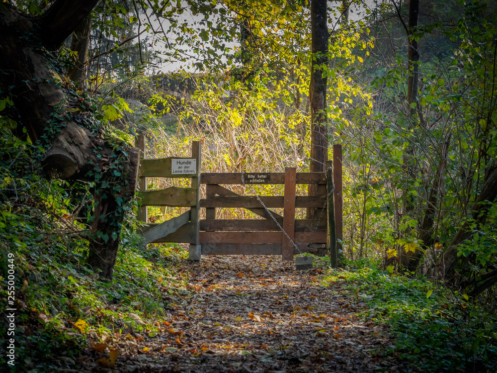 Wooden gate to a pasture with warning signs Wooden gate to a pasture with warning signs